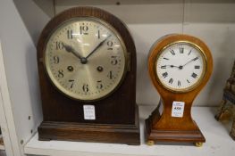 A small Edwardian mahogany balloon shaped mantel clock and another clock.