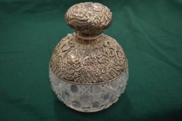 A large silver mounted cut glass scent bottle.