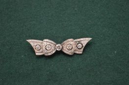 A good gold and diamond set bow shaped brooch.
