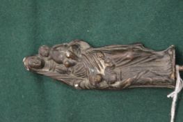 A small cast bronze group of Madonna and children with a wooden stand.