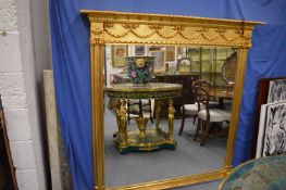 A large gilt framed over mantel mirror.