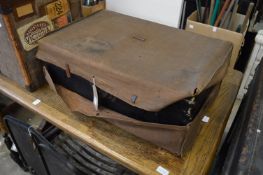 A lacquer trunk with outer canvas cover.