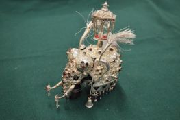 An Indian white metal mounted and gem set model of an Indian parade elephant.