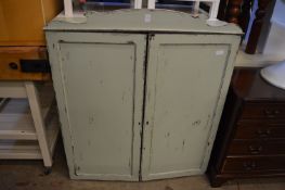 A green painted two door cupboard.