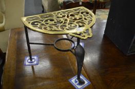 A brass and wrought iron trivet.