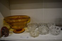 An amethyst glass pedestal bowl and other glassware.