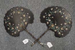A pair of Victorian papier mache hand fans painted with flowers.