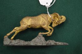 Gilt bronze figure of a ram on a stylised bronze base.