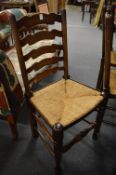 A set of eight rush seated beech ladderback dining chairs.
