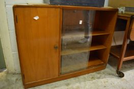 A bookcase with sliding glass doors.