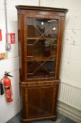 Reproduction mahogany standing corner cabinet.