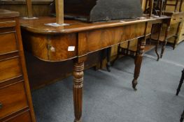 A 19th century mahogany single drop-flap dining table on turned and reeded legs.
