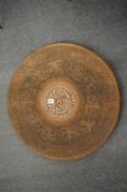 An Eastern carved hardwood and inlaid circular table top.