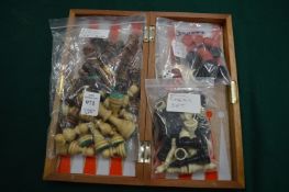 A folding games board with chess and other pieces.