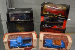 A group of boxed die-cast vehicles.