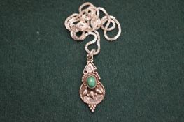 Decorative silver pendant and chain.