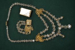 Decorative glass bead necklace and matching bracelet together with a ladies cigarette lighter.