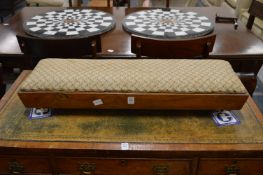 A Victorian walnut framed long footstool.