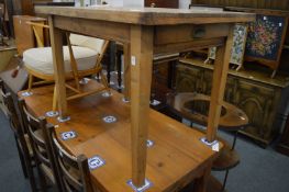 A pine kitchen table with a drawer to one end.