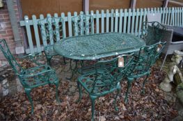A green painted aluminium garden table with six chairs, two with arms.