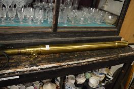 A brass telescope with tripod stand.