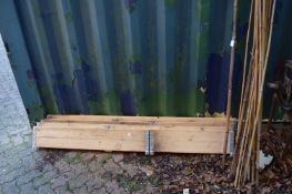 A set of four folding raised beds and a quantity of bamboo canes.