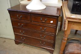 A reproduction mahogany chest of drawers.