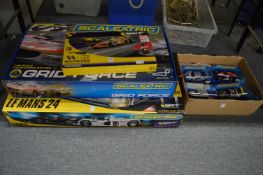 Two boxed Scalextric sets, a banking track set and four separate Scalextric cars, boxed.