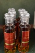 Six miniature bottles of Rastignac XO cognac.