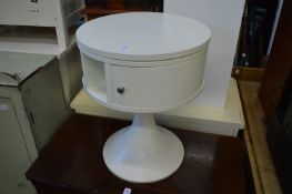 A white painted laminate circular table with revolving central section.