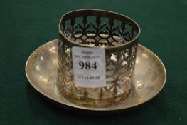 A pierced white metal stand.