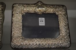 An embossed silver photograph frame.
