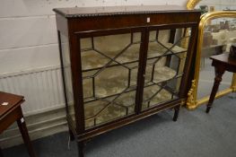 A mahogany display cabinet with pair of astragal glazed doors.
