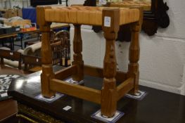 Robert Thompson, a mouseman stool with leather latticework top.