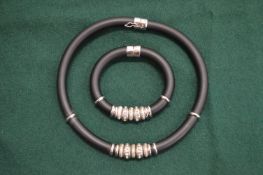 A decorative modern design choker and matching bracelet.