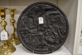 Decorative cast iron circular plaque.
