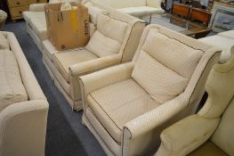 A two seater settee and matching armchair together with a set of extra loose covers.