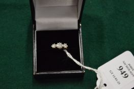 A gold and diamond three stone ring.