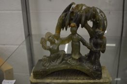 A Chinese carved jadeite group on stand.