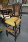 An 18th century style oak high chair.