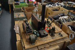 A Stuart stationary engine with spirit burner and accessories.