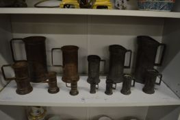 A set of seven Continental pewter measures and another set of measures.