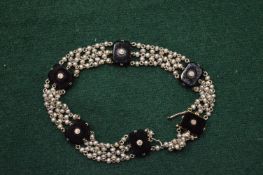 A gold, diamond and onyx set bracelet (damaged).