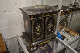 A good 19th century papier mache table cabinet with painted and inlaid decoration, the rising top