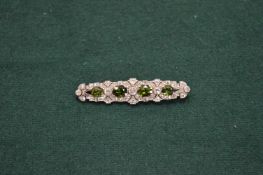 A good white metal diamond and Tourmaline set bar brooch.