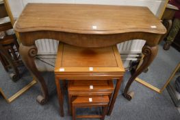 A walnut console table with carved cabriole legs.