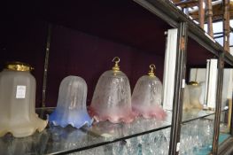 A quantity of colour and opaque glass light shades.