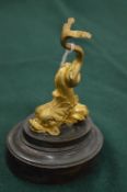 Gilt bronze model of a stylised dolphin mounted on a bronze base.