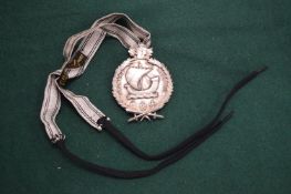 A French silver plated bronze medal with laurel wreath and oak leaf mounts.