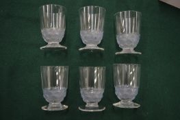 A set of six small Lalique shot glasses, the bases with a band of stylised fish.